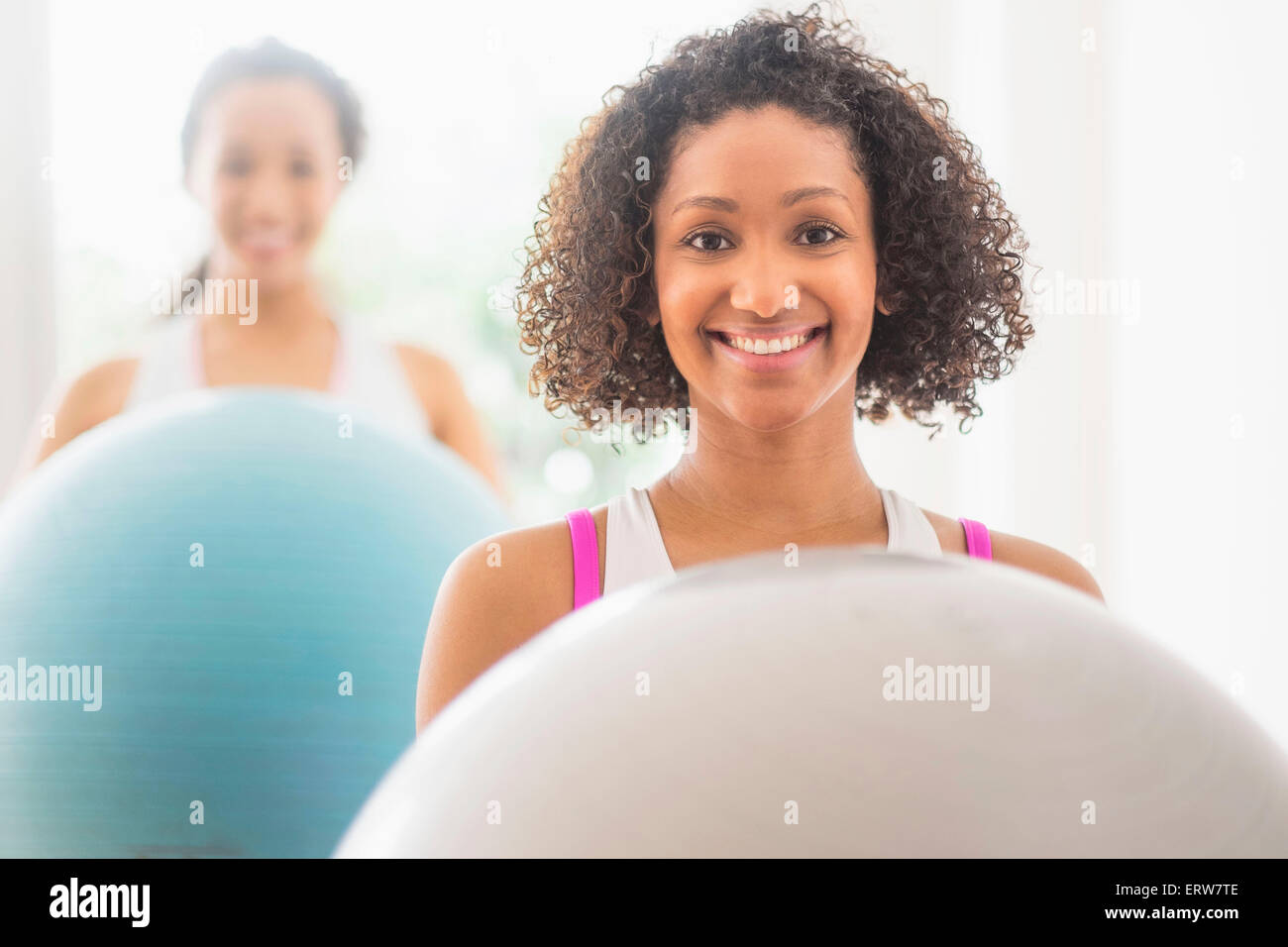 Women working out with fitness balls in exercise class Stock Photo