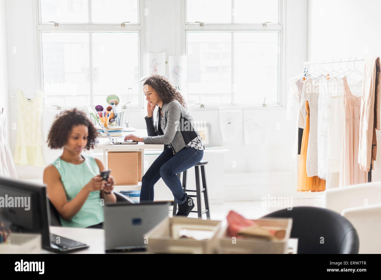 Businesswomen working at desks in office Stock Photo