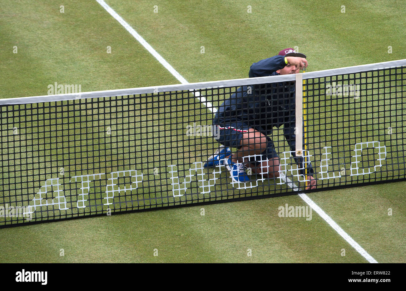 Stuttgart, Germany. 08th June, 2015. A man measures the height of the net during the ATP tournament in Stuttgart, Germany, 08 June 2015. Photo: MARIJAN MURAT/dpa/Alamy Live News Stock Photo