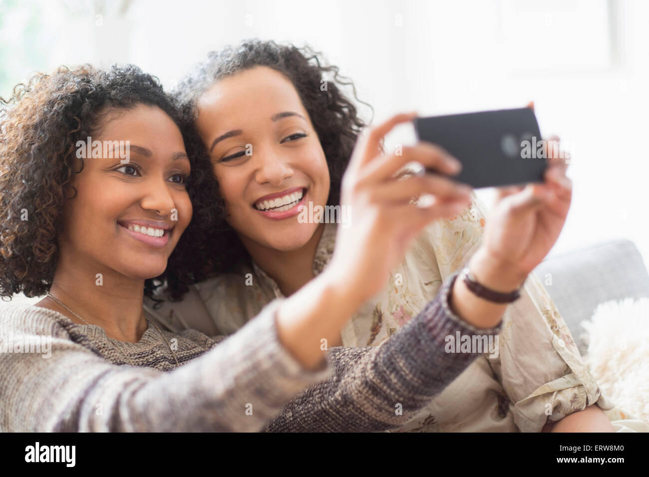 Smiling women taking cell phone photograph Stock Photo