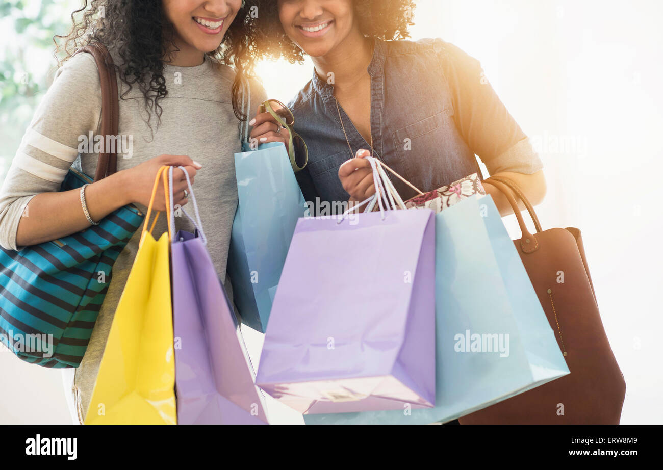 Smiling women carrying shopping bags Stock Photo