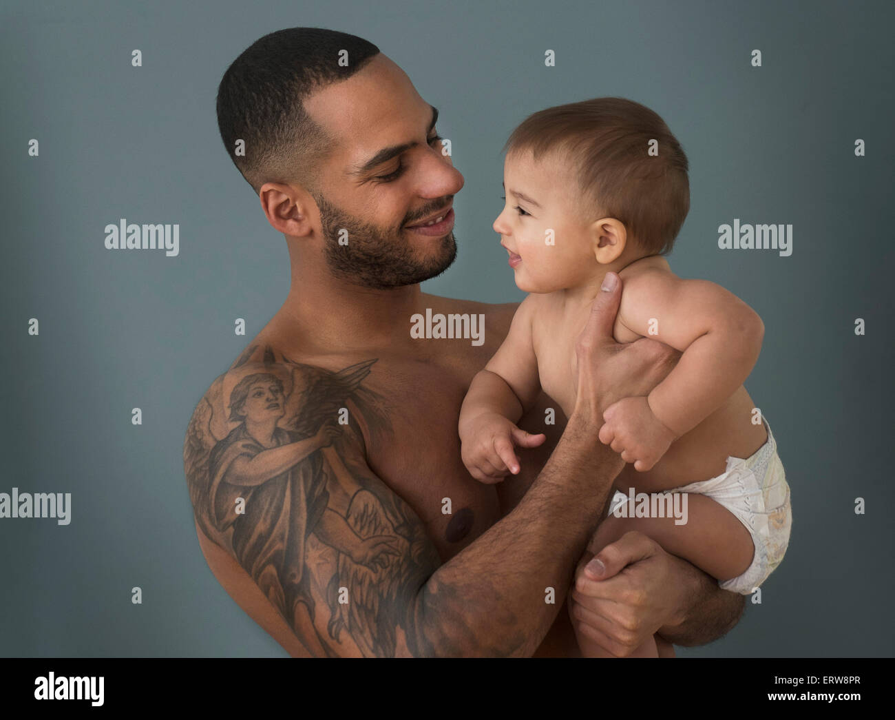 Father with tattoos holding baby son Stock Photo - Alamy Father with tattoos holding baby son Stock Photo - Alamy