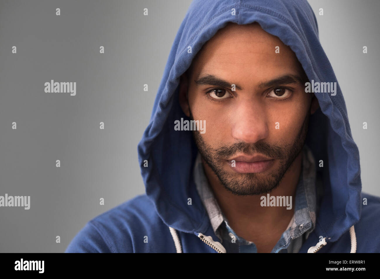 Serious Hispanic man wearing hoodie Stock Photo - Alamy
