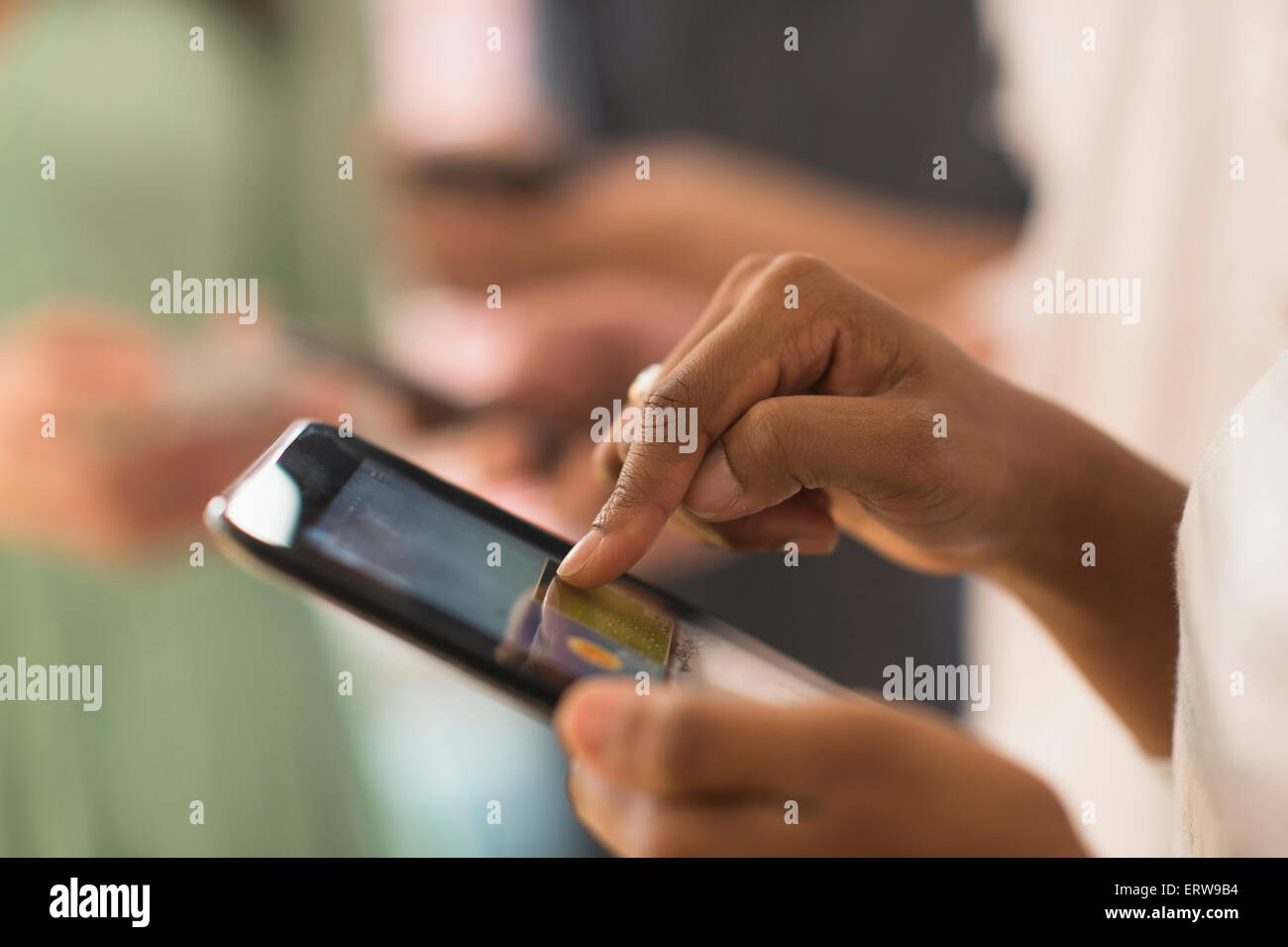 Close up of woman using cell phone touch screen Stock Photo