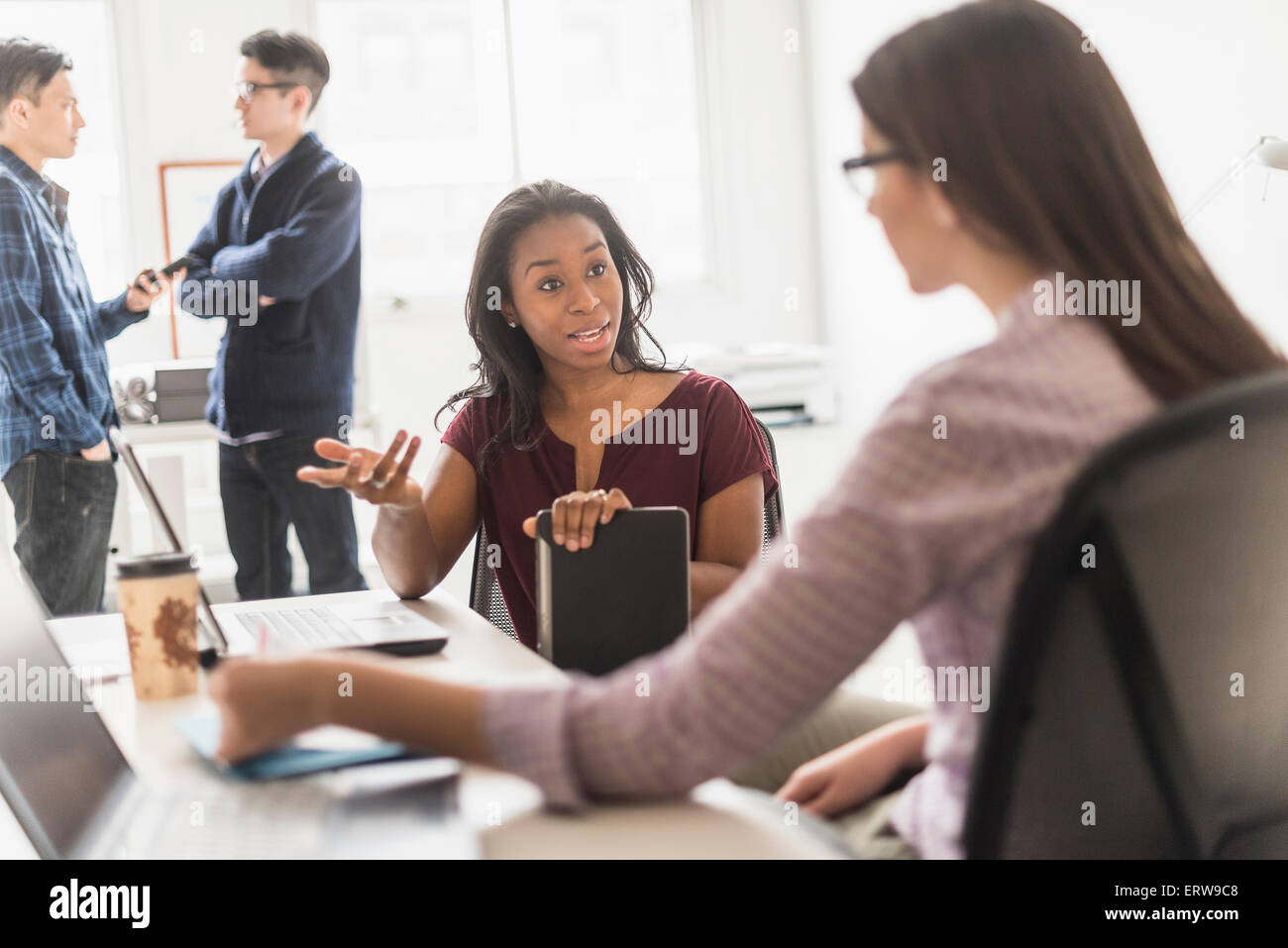 Businesswomen working together in office Stock Photo