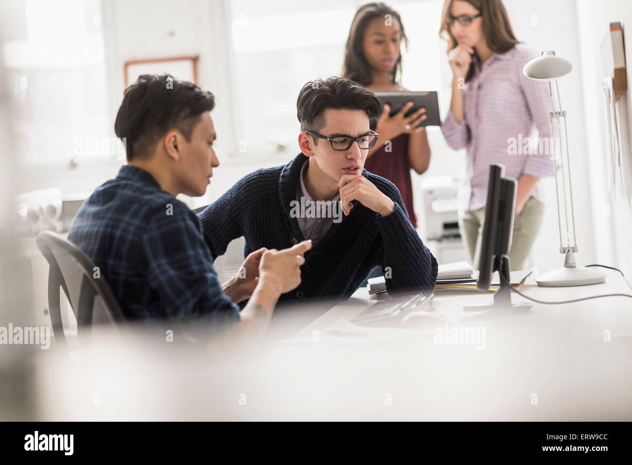 Businessmen working together in office Stock Photo