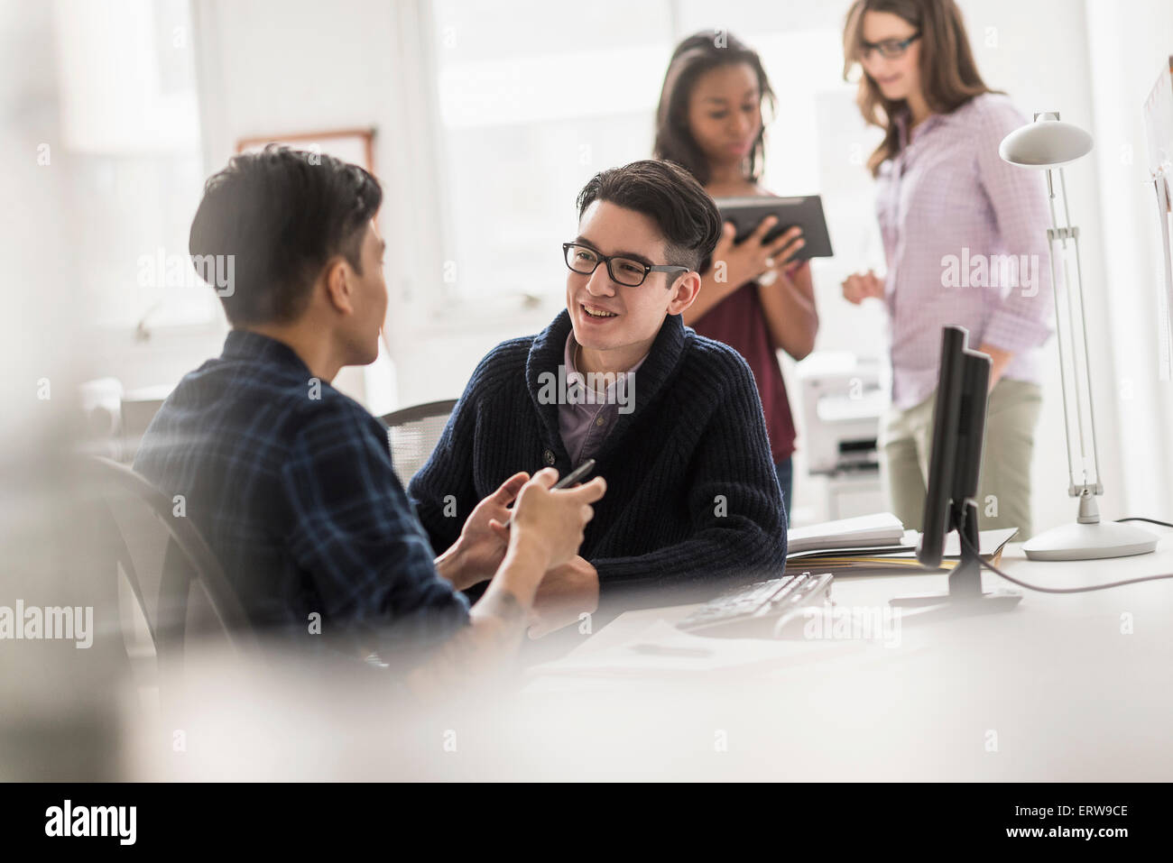 Businessmen working together in office Stock Photo