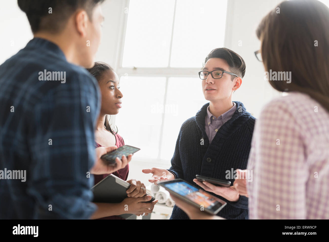 Business people working together in office with technology Stock Photo