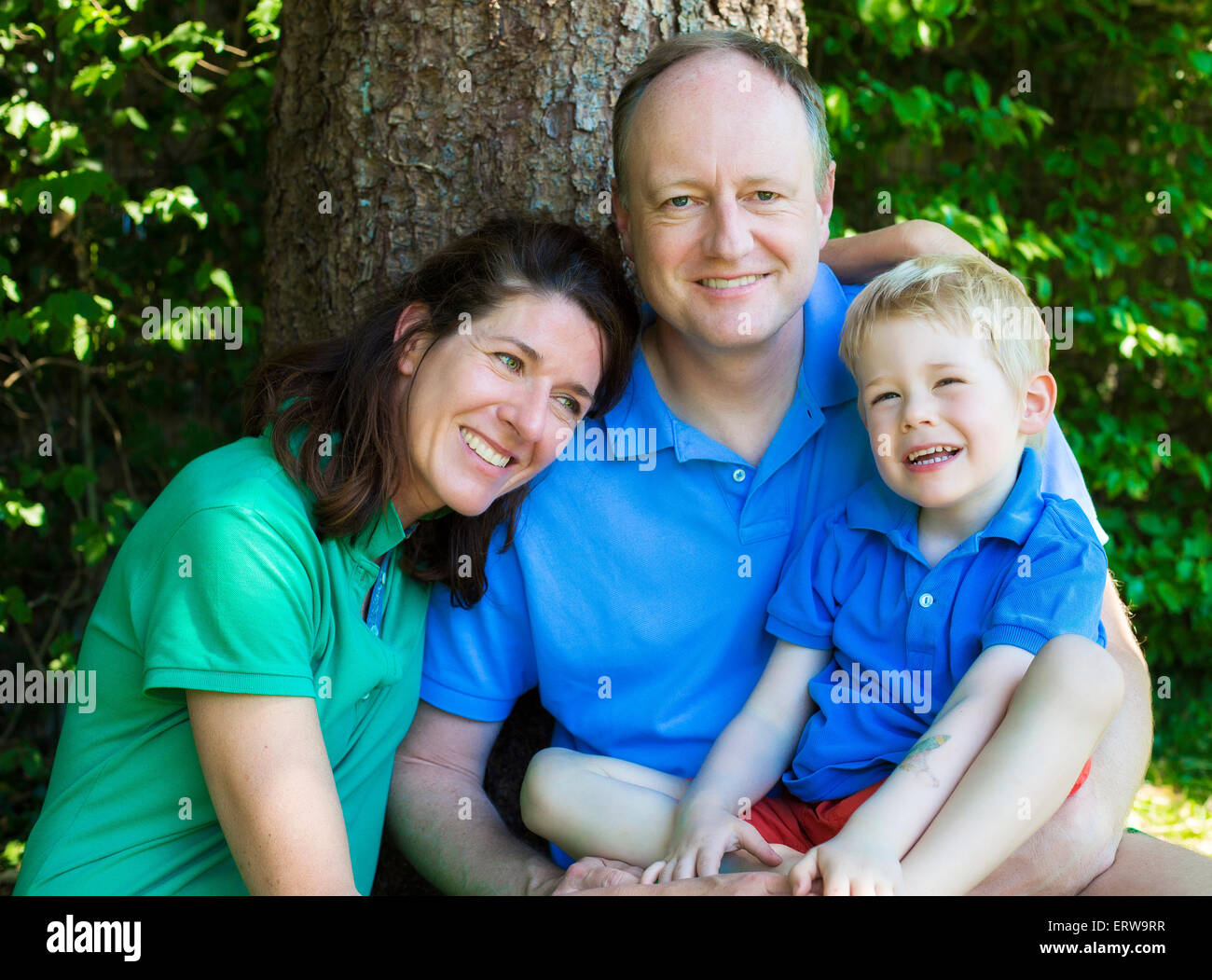 portrait of a family in front of a tree Stock Photo