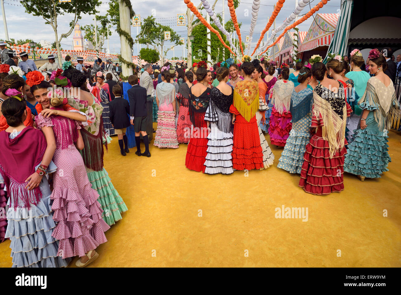 Young female students dressed in flamenco dresses at the April Fair in Seville Stock Photo