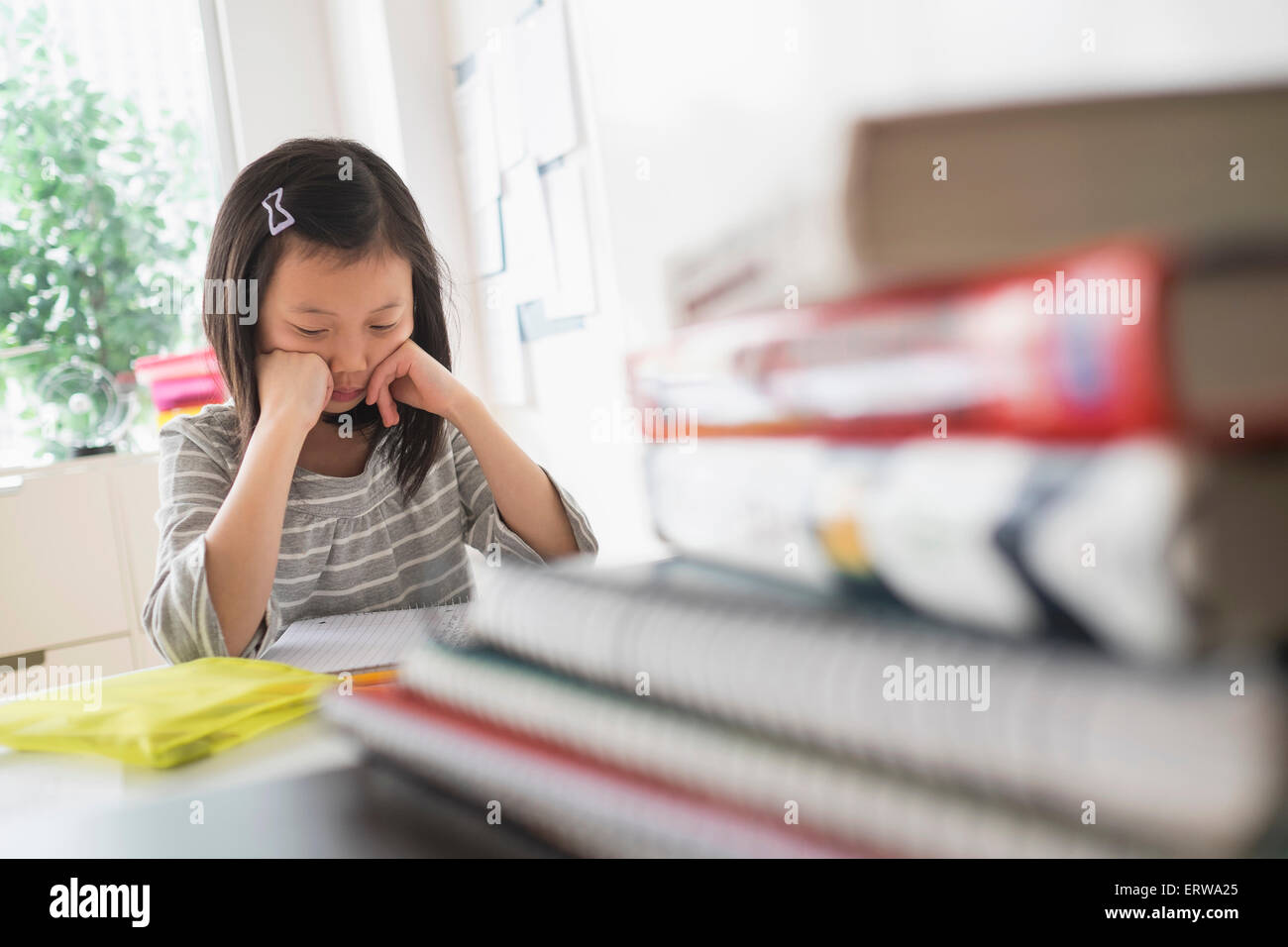 Chinese student thinking about homework Stock Photo
