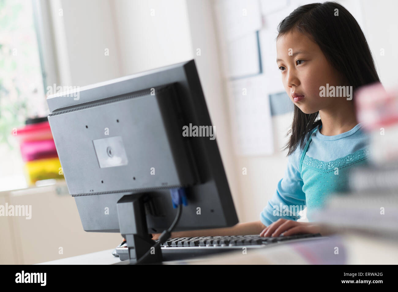 Chinese student using desktop computer Stock Photo