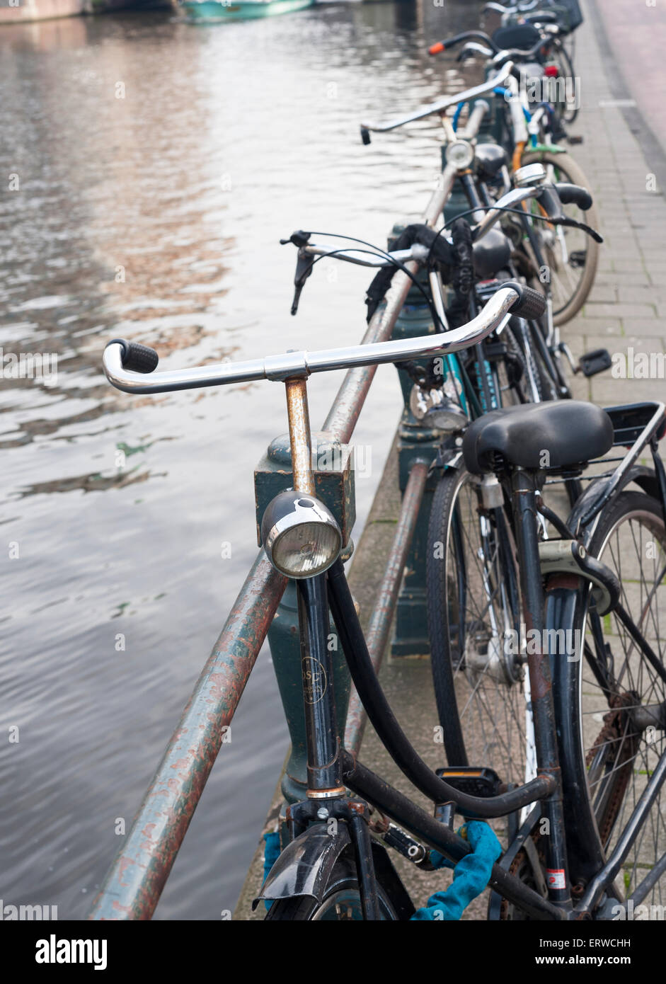 row of bikes along an Amsterdam canal Stock Photo Alamy