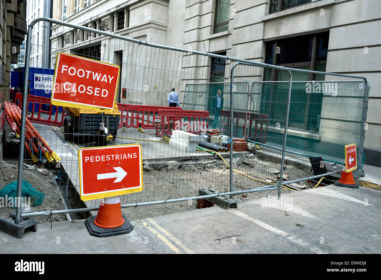 Footway closed sign with arrowed sign redirecting pedestrians around road works, City of London, England Britain UK Stock Photo