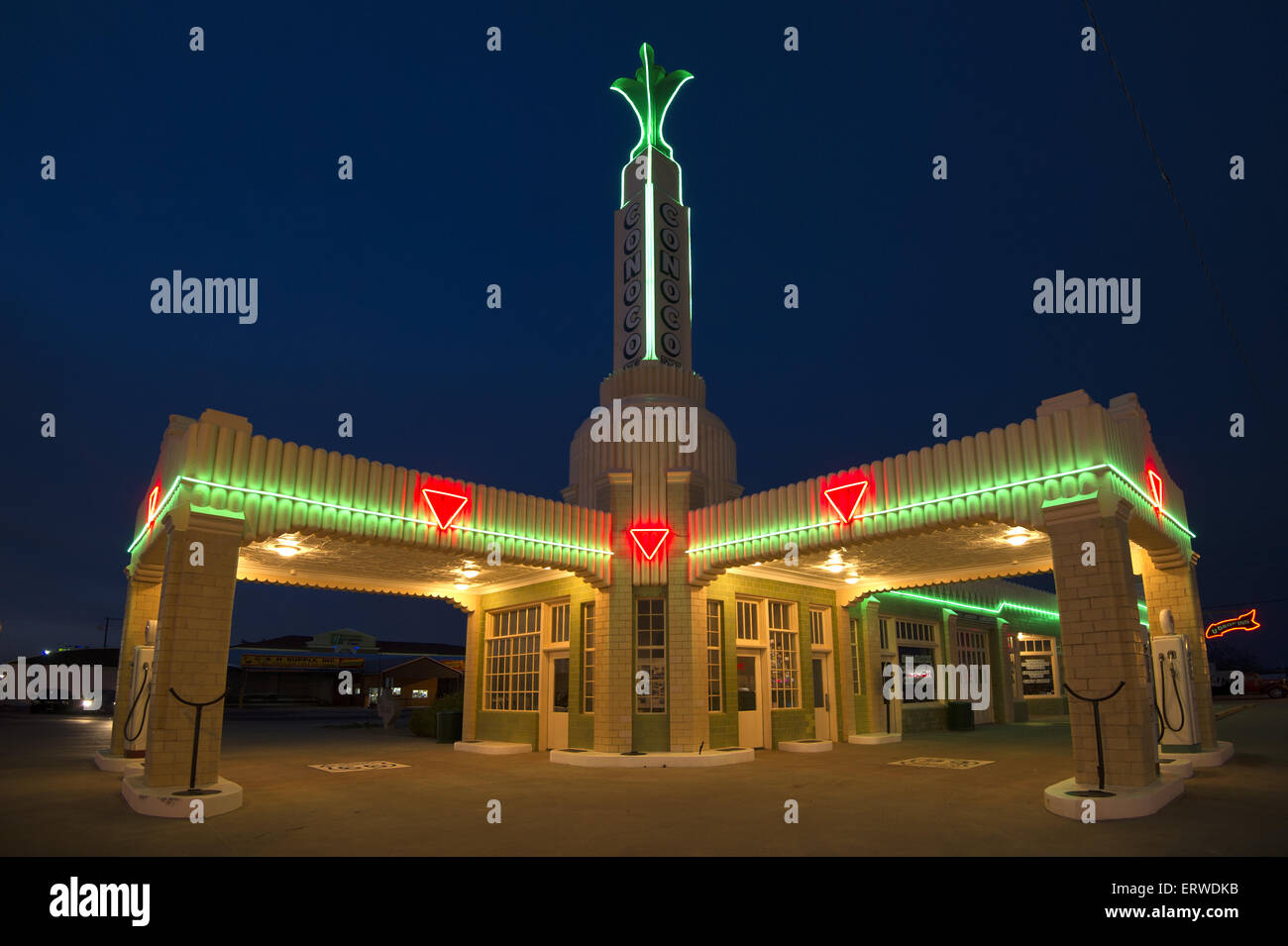 The famed Conoco Tower gas station and U-Drop-Inn on historic Route 66 located in Shamrock, Texas lit up with neon in the night. Stock Photo
