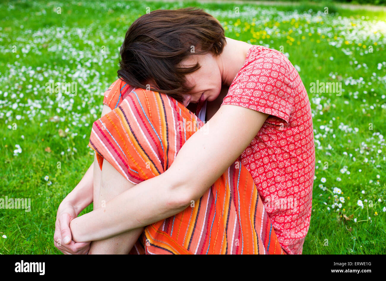 Sad girl sitting grass hi-res stock photography and images - Alamy