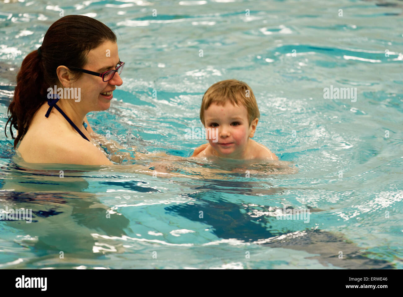 A young boy (two and a half years old) learning to swim Stock Photo