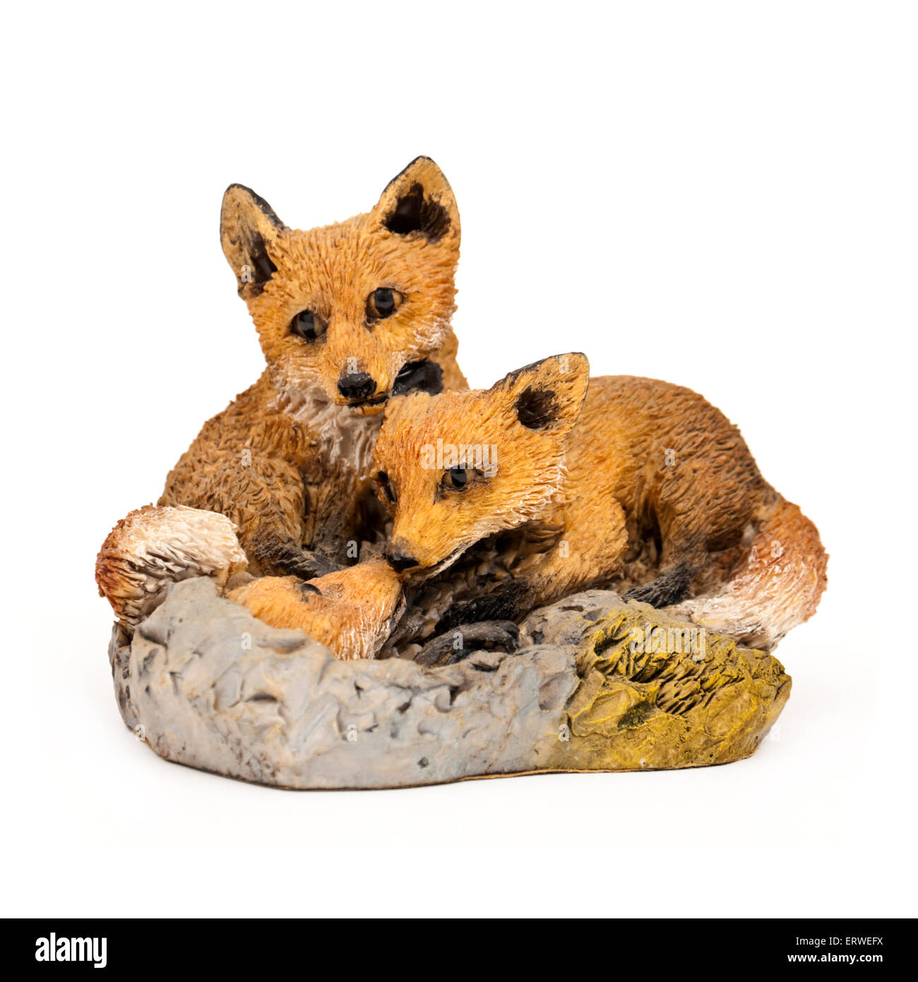 Handpainted ornament of a pair of foxes looking after their cub Stock Photo