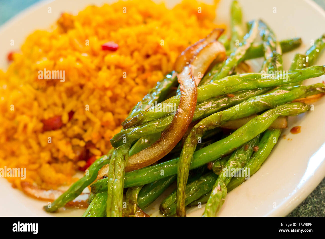 Chinese sauteed string beans in a brown oyster sauce with pork fried