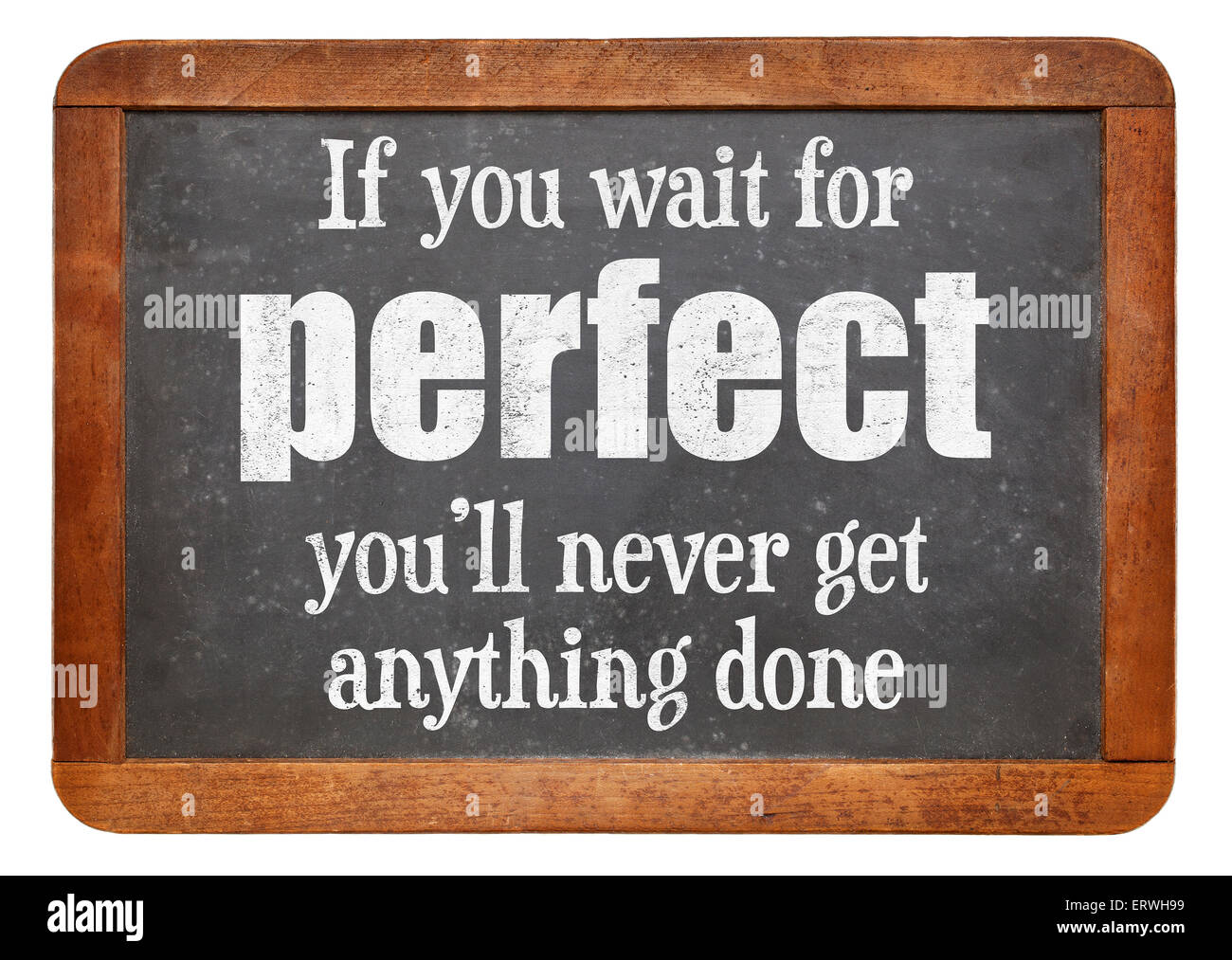 If you wait for perfect you will never get anything done - words of wisdom on a vintage slate blackboard Stock Photo
