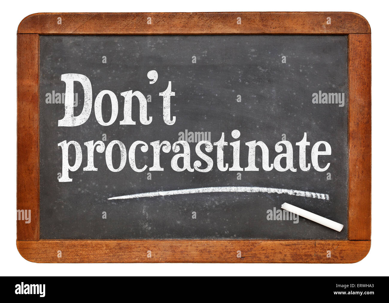 Do not procrastinate advice on a vintage slate blackboard Stock Photo