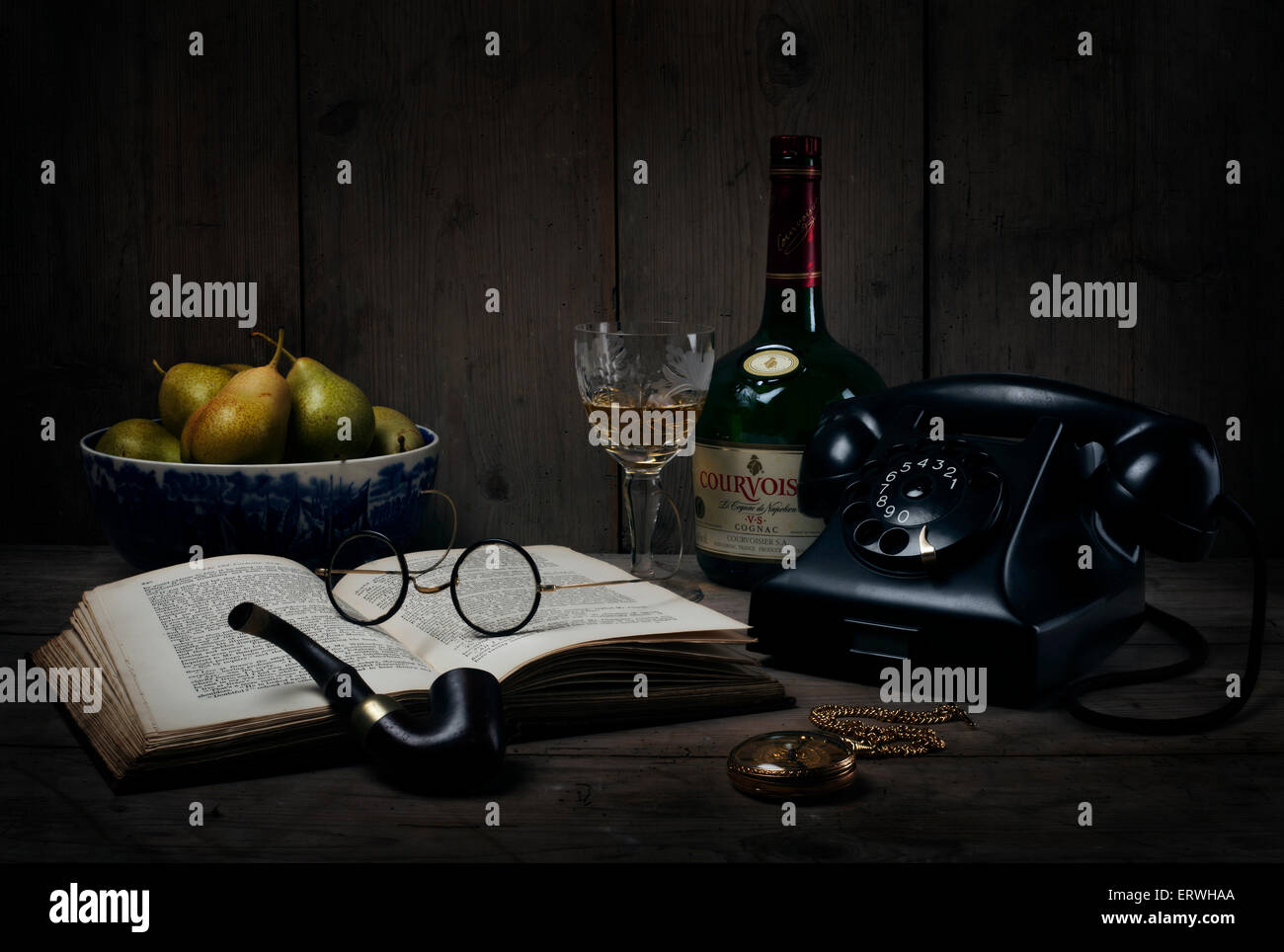 Still Life - 1930's/1940's/1950's telephone, book, pipe, pocket watch, glasses, book and brandy Stock Photo