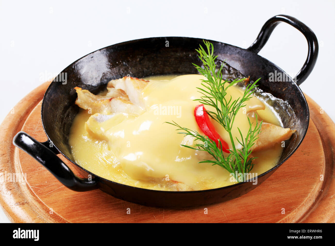 Pan-seared white fish with rich sauce Stock Photo - Alamy