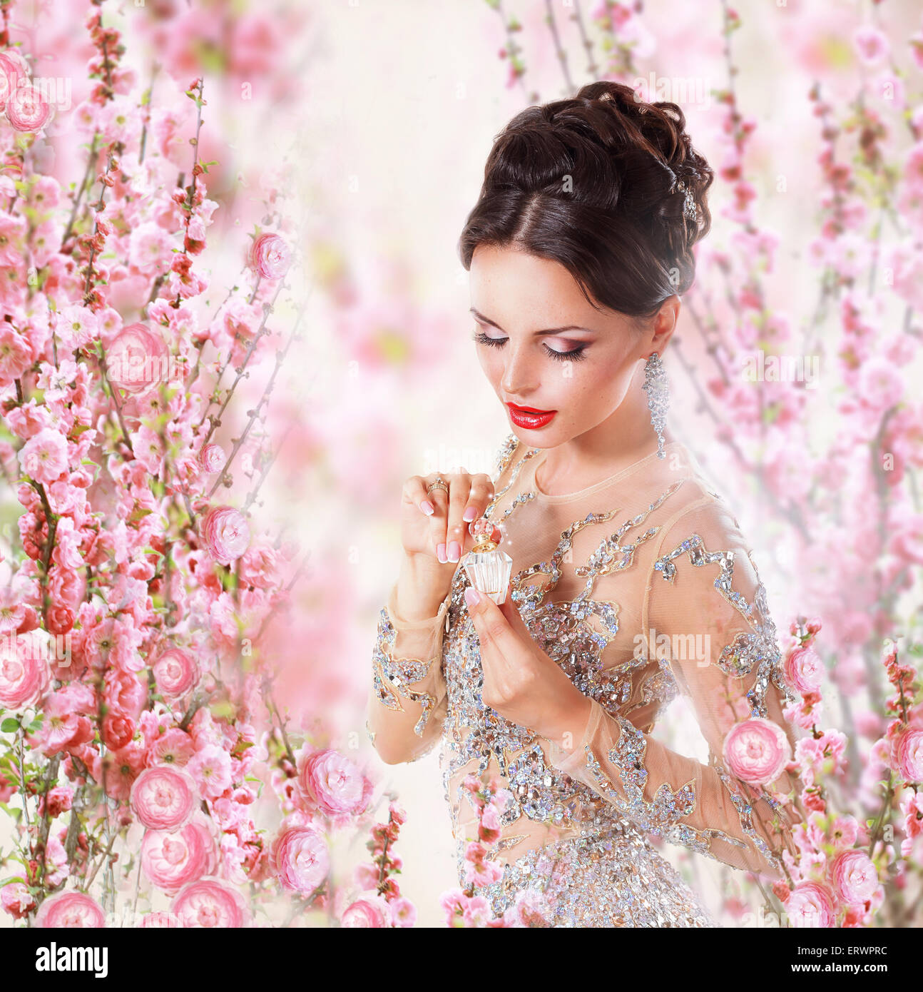 Woman with Perfume over Floral Background Stock Photo