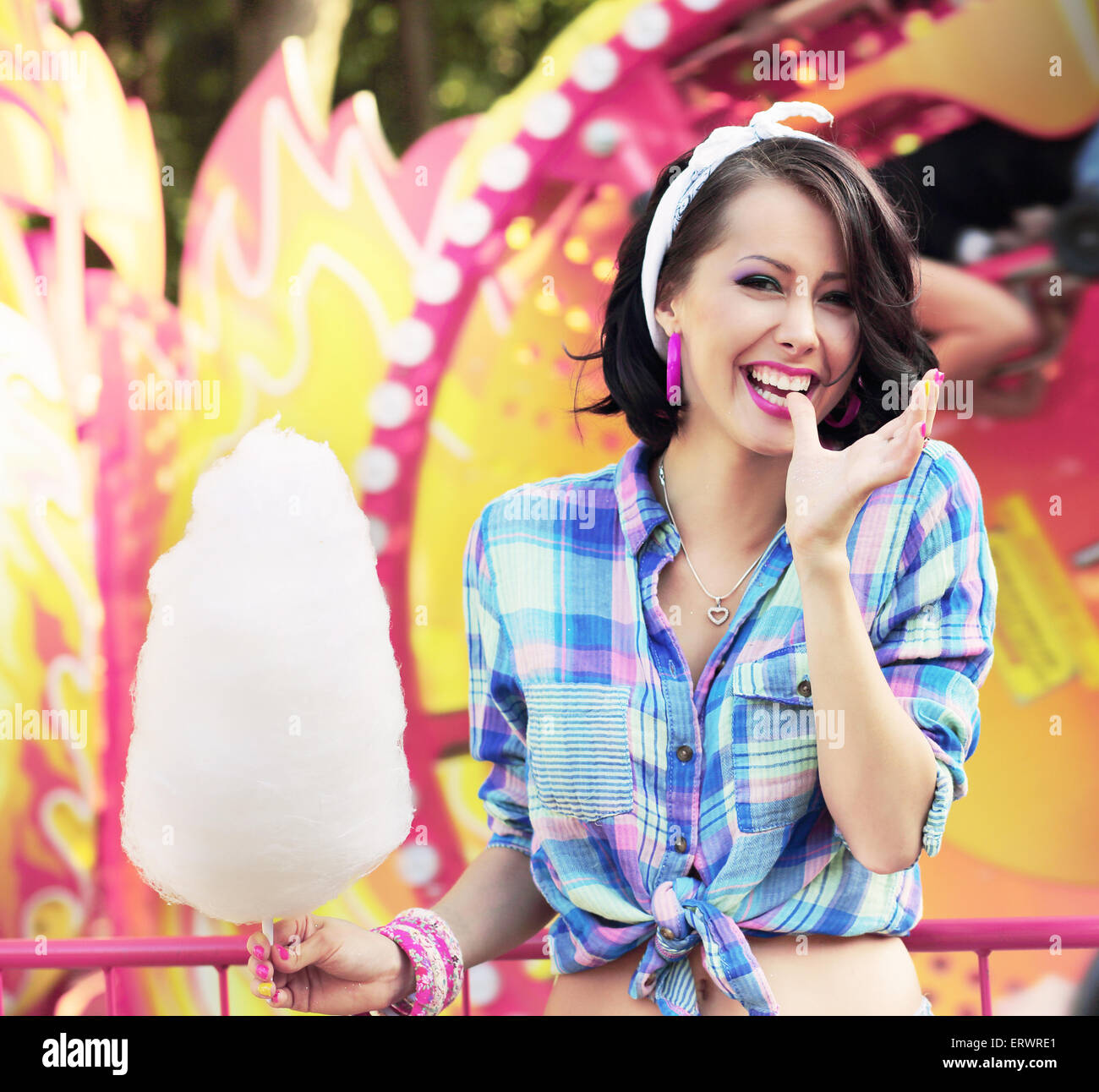 Toothy Smile. Young Woman with Cotton Candy in Amusement Park Stock Photo