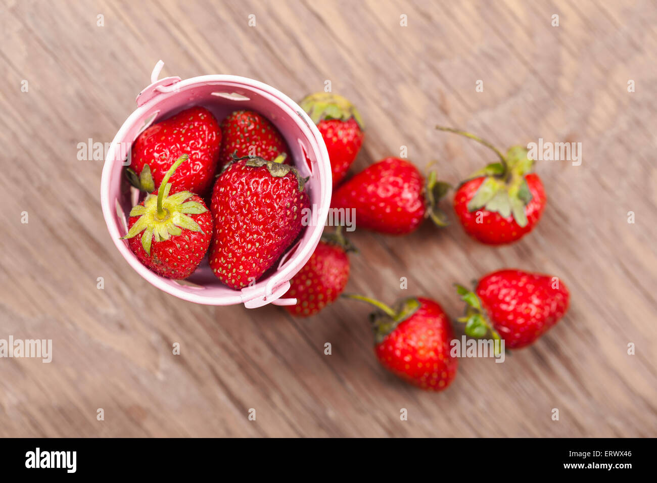 bucket of ripe strawberries on a wooden background Stock Photo - Alamy