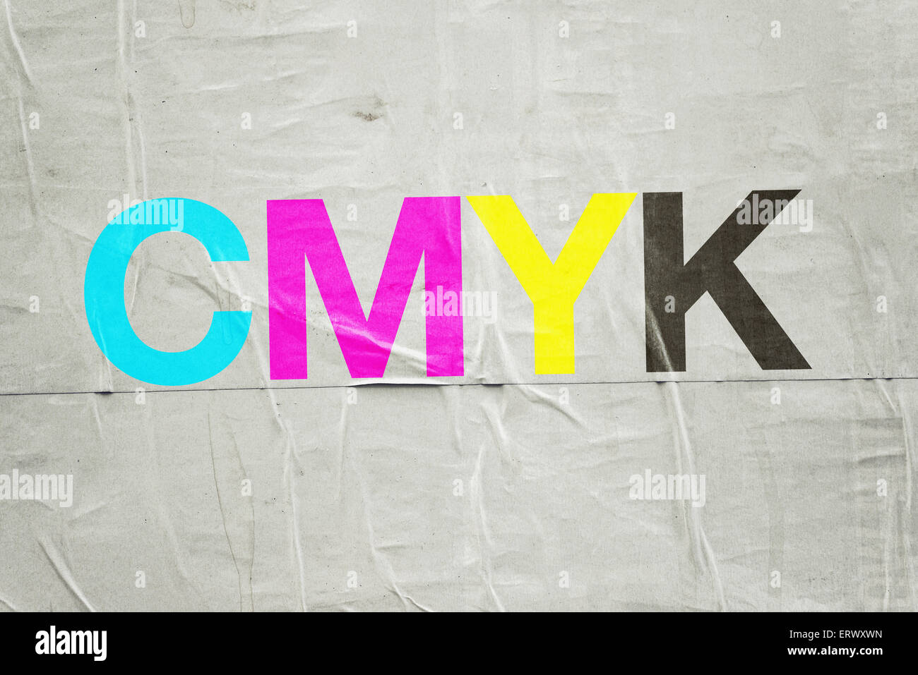 CMYK Digital Printing Technology with Cyan, Magenta, Yellow and Black Letters on Glued Poster Paper Stock Photo