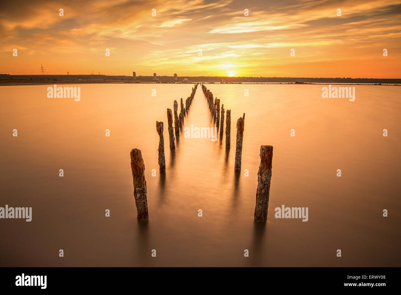 Poles in the water, on sunset clouds and ocean- calmness and silence concept Stock Photo