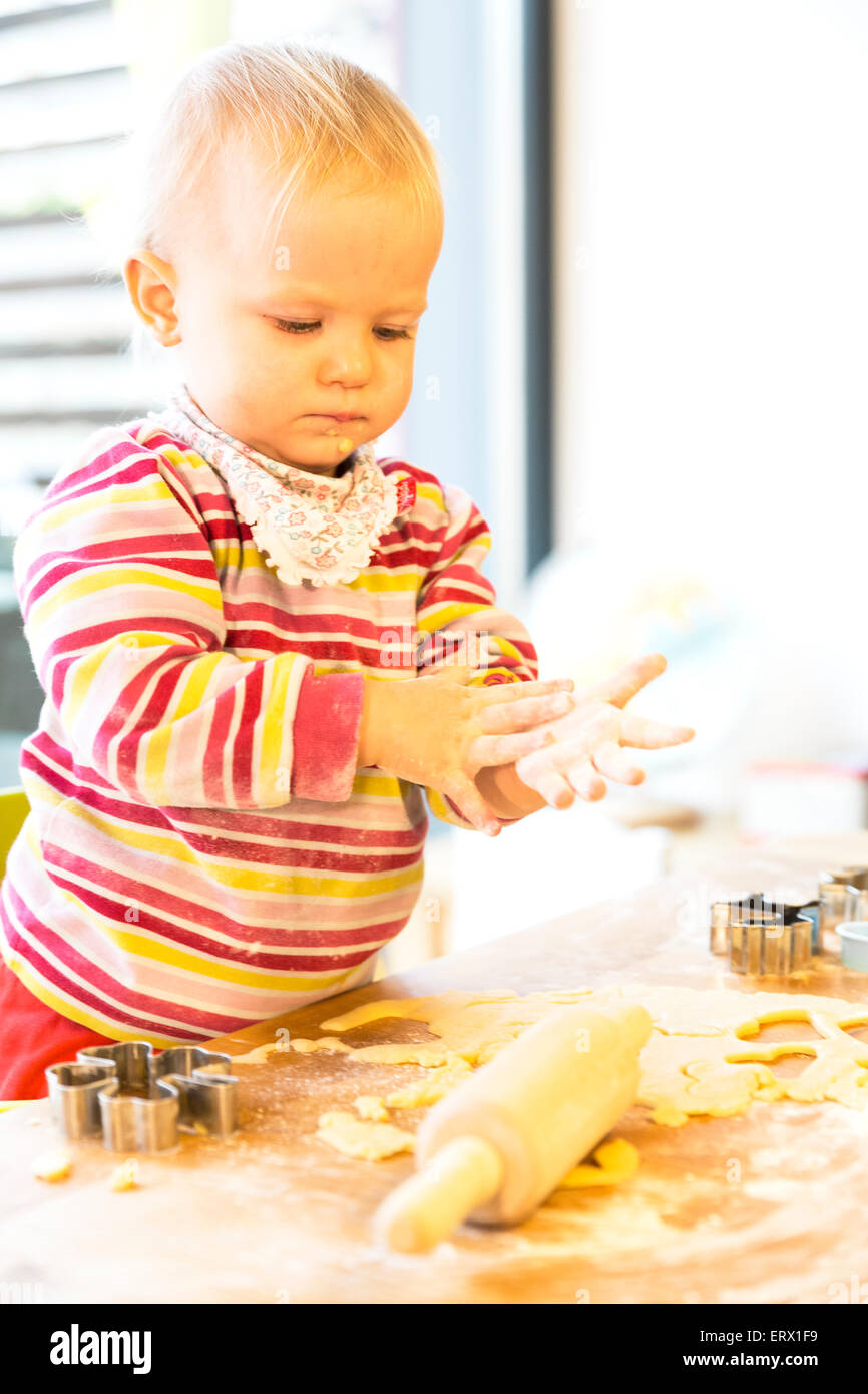 Toddler, two years, baking biscuits at Christmas time Stock Photo