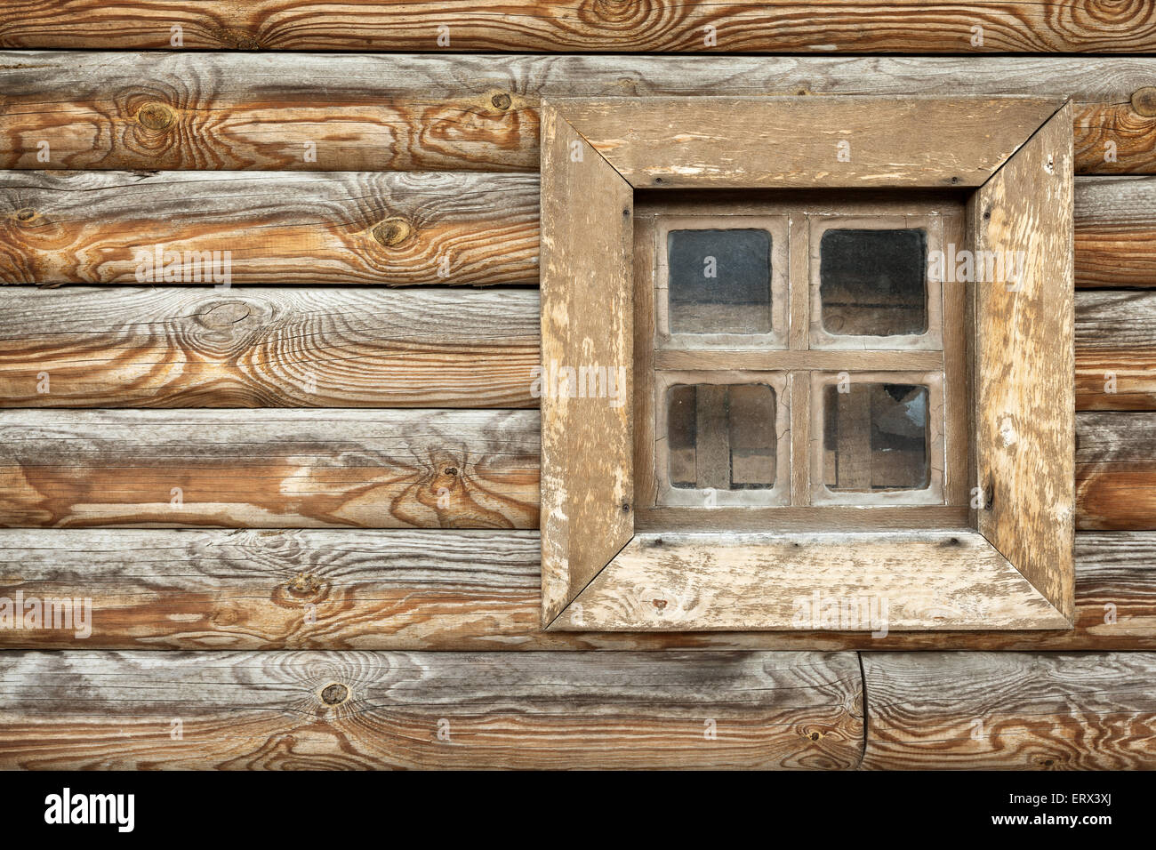 Old window of the old wooden house on the background of wooden walls Stock Photo