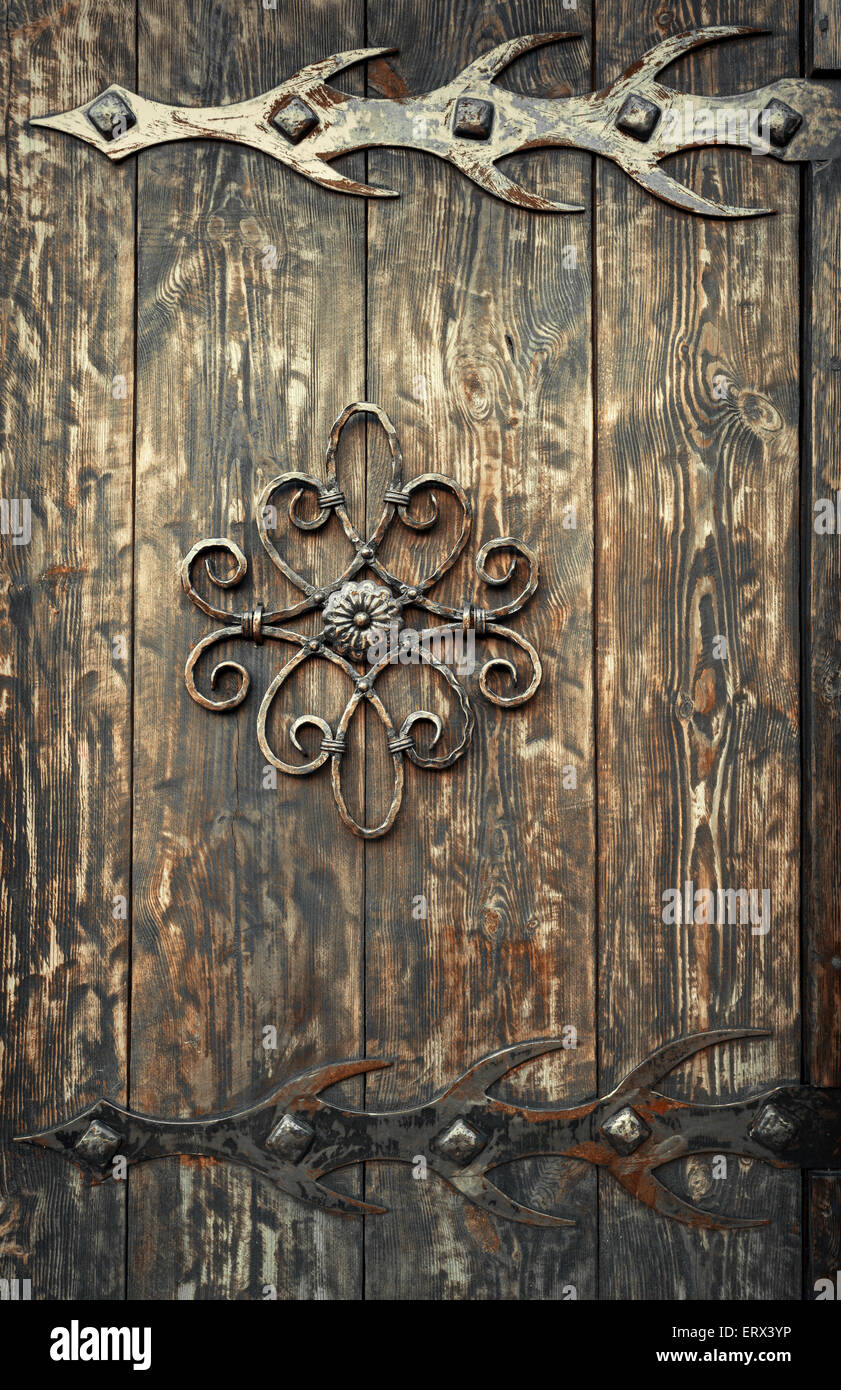 old rusty decorative element and wood door. Background for design Stock Photo