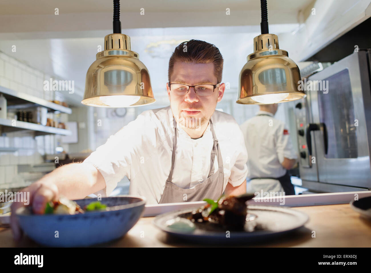 Chef keeping food bowl on counter in kitchen Stock Photo - Alamy