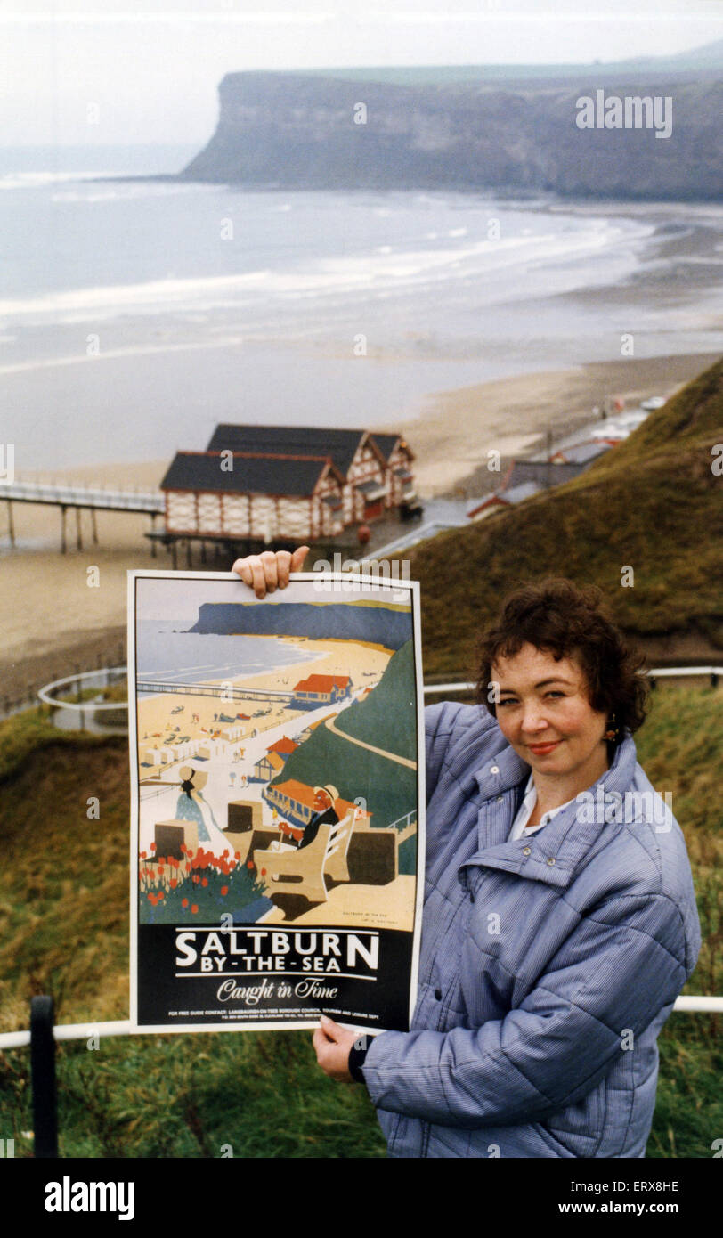 Saltburn has beaten the likes of Blackpool and Brighton to a national promotion award. A replica railway publicity poster, displayed by tourist information assistant Kate Winspear against the backdrop of the original view, caught the eye of the judges and helped Saltburn bring home the winner's trophy in the 60th year of the competition. 16th November 1992. Stock Photo