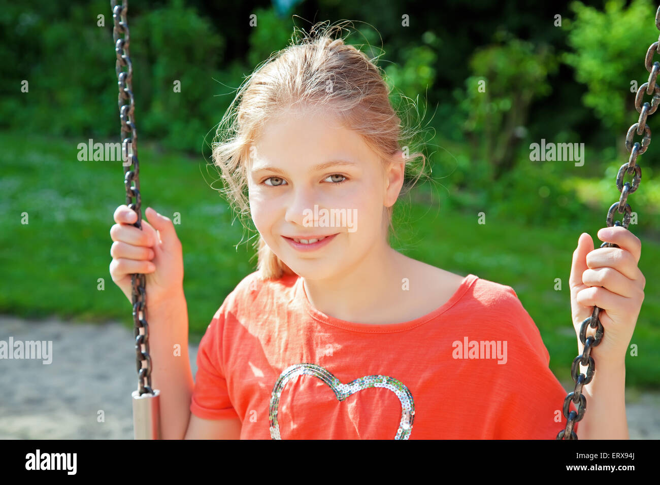 happy young girl on a swing Stock Photo