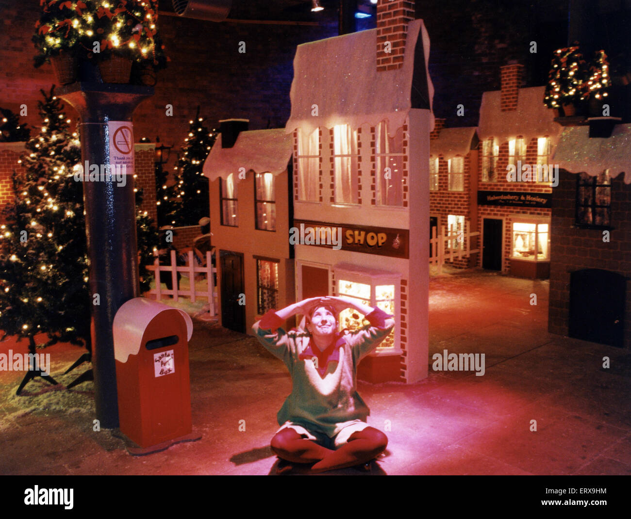 An elf sits in the middle of Santa's grotto at the Albert Dock, Liverpool, waiting to greet visitors. 30th November 1995 Stock Photo