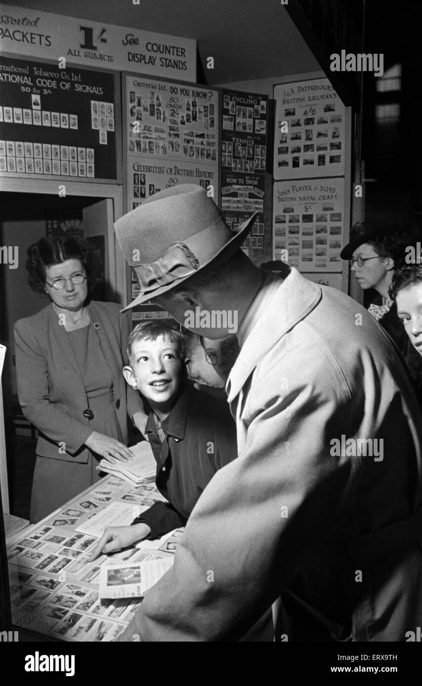 School boys at the 1948 Model Engineer Exhibition at Seymour Hall, London. Children looking at collectable cigarette cards. January 1948 Stock Photo