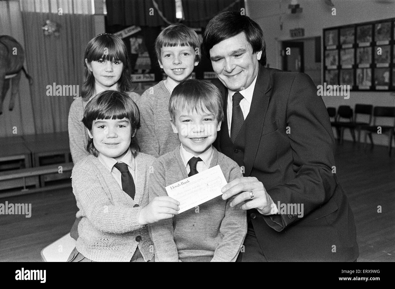 Lepton C of E Church school pupils present cheque for ¿127 to RNIB appeals organiser Michael Tottle. 18th December 1985. Stock Photo