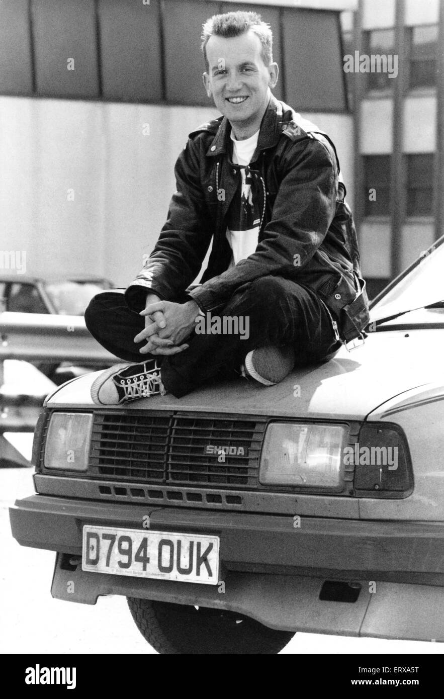 Comedian Frank Skinner who has just returned from the Edinburgh Festival, sitting on top of a car, 7th September 1990. Stock Photo