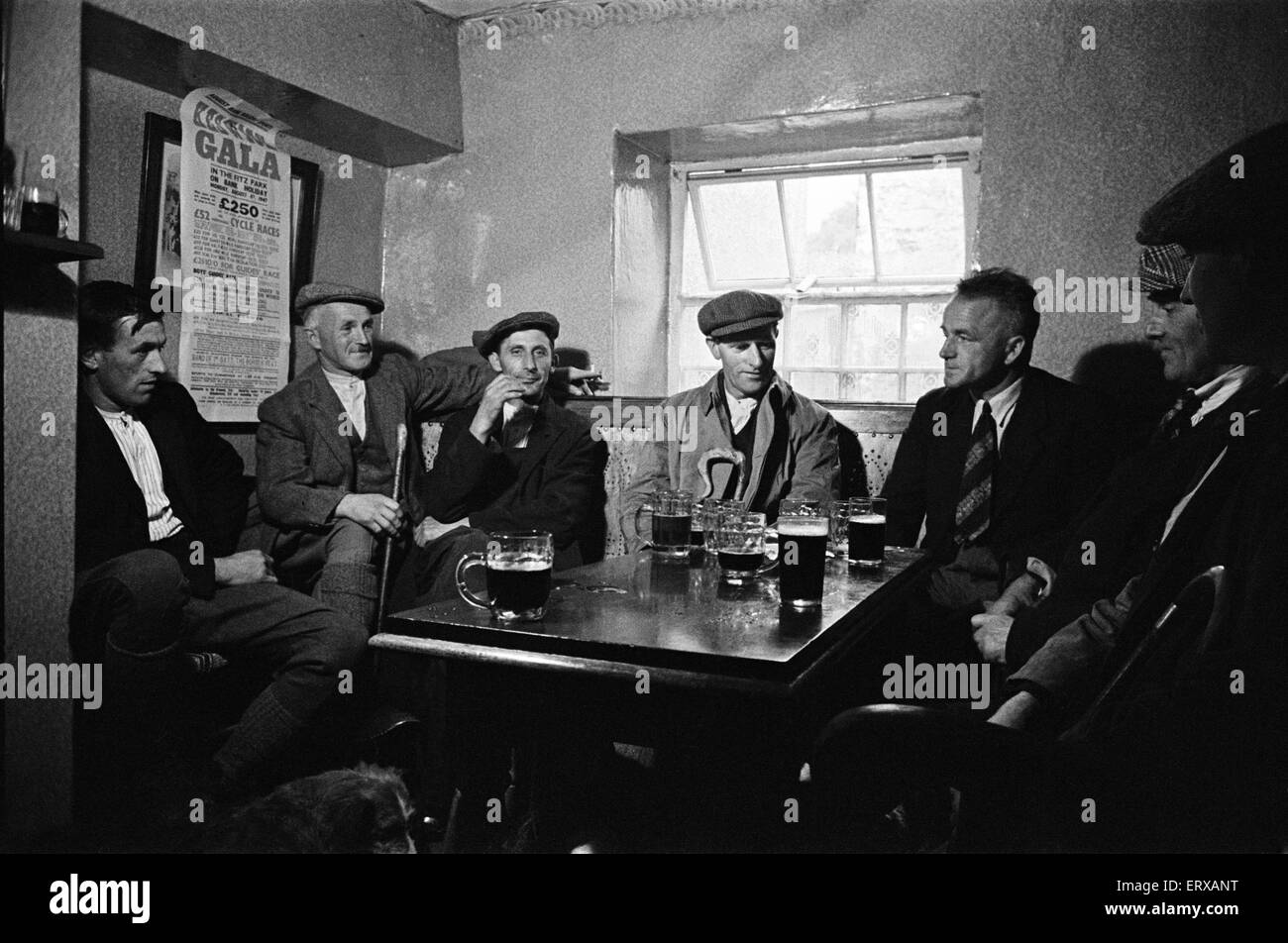 Men enjoying a pint at the Royal Oak Inn, in Braithwaite village near Keswick, Cumbria, circa July 1947. Stock Photo