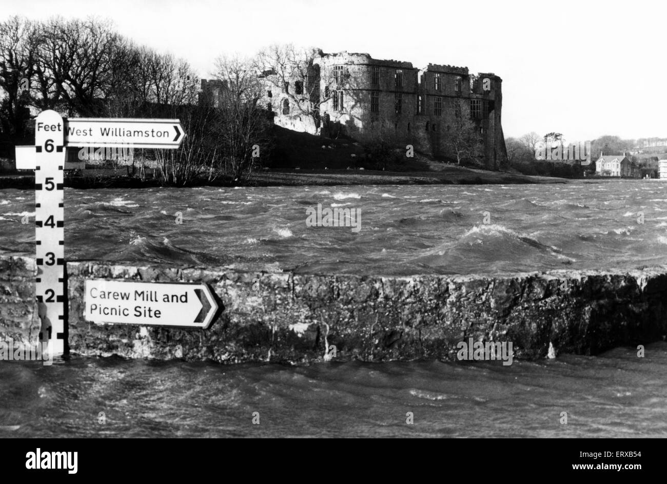 Carew Castle, a castle in the civil parish of Carew in the Welsh county of Pembrokeshire, Wales, 27th February 1990. Pictured, Flooding at CarewCastle on the Pembroke to Canaston Bridge. Stock Photo