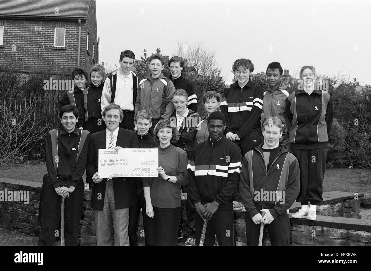 Harry Gration at Leeds Road playing fields to receive a cheque for Children in Need, from first year City and Guilds Recreation and Leisure Industries course students from Huddersfield Technical College, 26th January 1989. Stock Photo