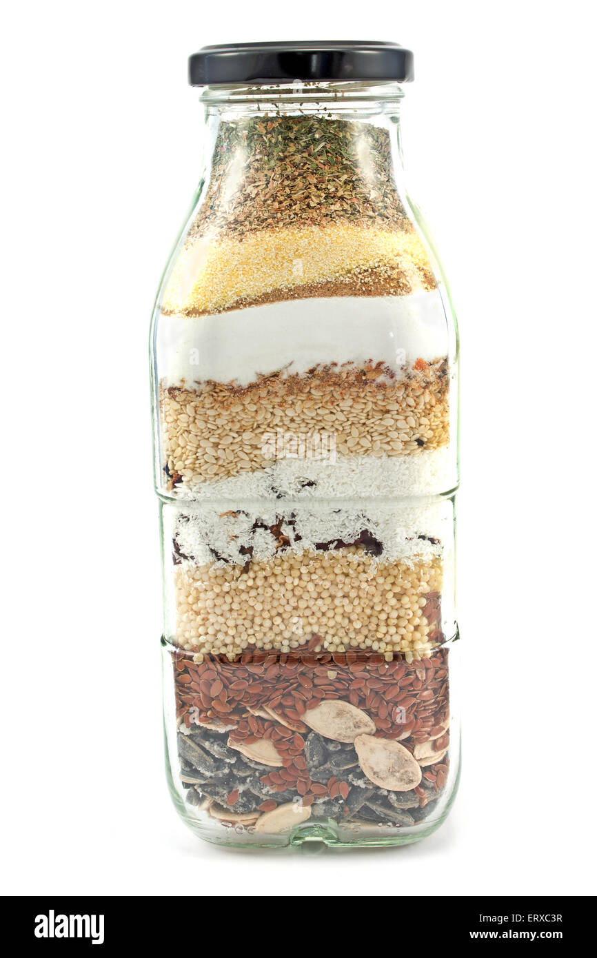 Decorative glass bottle with seeds isolated on white Stock Photo
