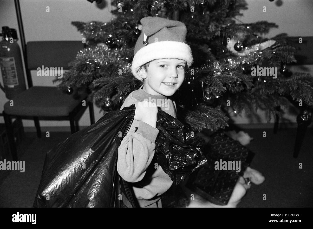 Daniel Bell came into the office with a sack of toys for the Examiner Christmas Toy Appeal. 16th December 1991. Stock Photo