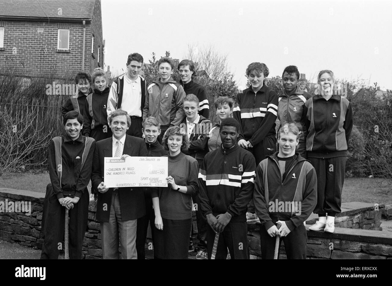Harry Gration at Leeds Road playing fields to receive a cheque for Children in Need, from first year City and Guilds Recreation and Leisure Industries course students from Huddersfield Technical College, 26th January 1989. Stock Photo