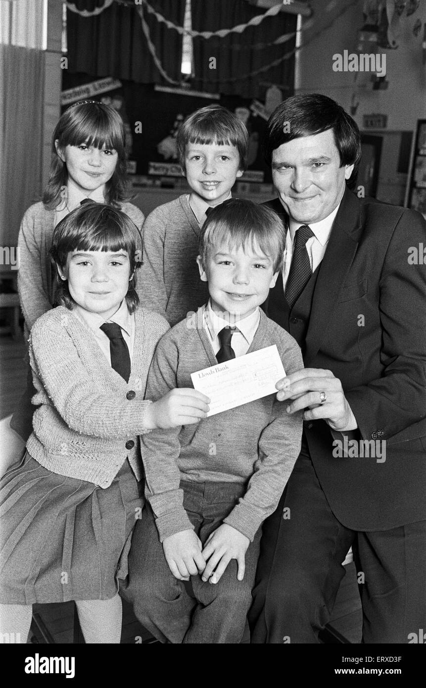 Lepton C of E Church school pupils present cheque for ¿127 to RNIB appeals organiser Michael Tottle. 18th December 1985. Stock Photo