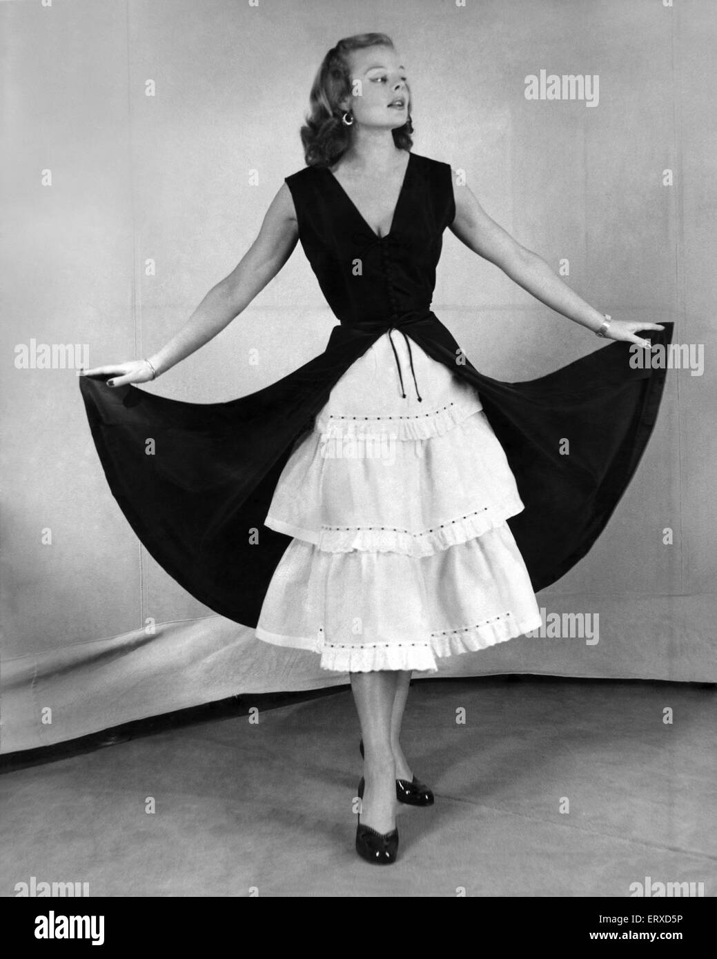 A model in a petticoat dress. December 1951 Stock Photo
